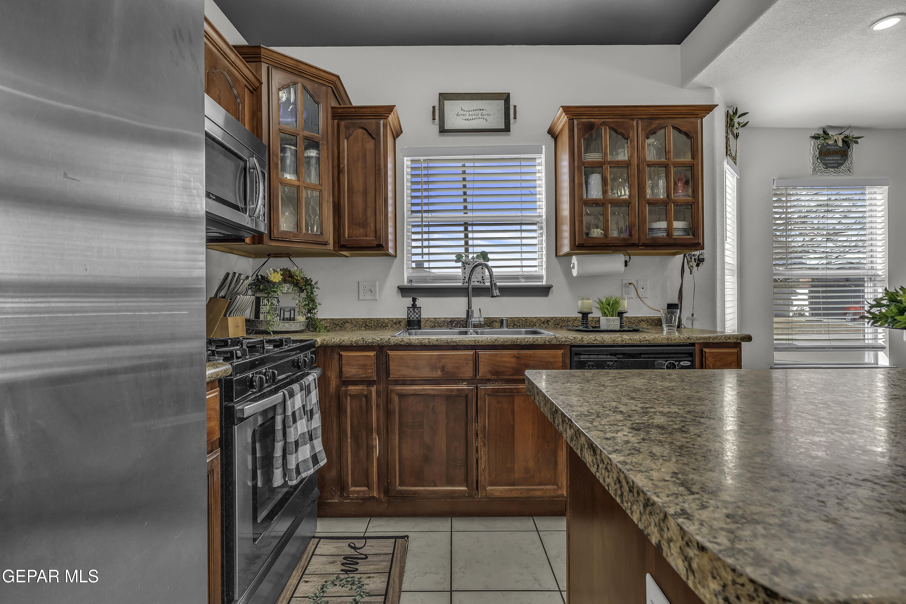 14401 Delta Point Court El Paso, TX 79938 - Photo 17 of 49 a kitchen with stainless steel appliances granite countertop a stove a sink and a microwave