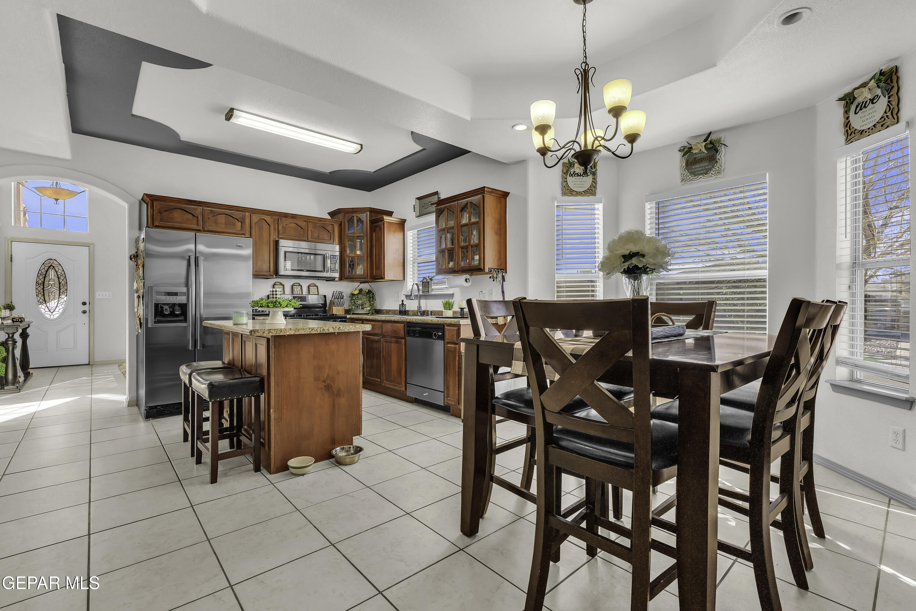 14401 Delta Point Court El Paso, TX 79938 - Photo 19 of 49 a dining room filled chandelier and glass door
