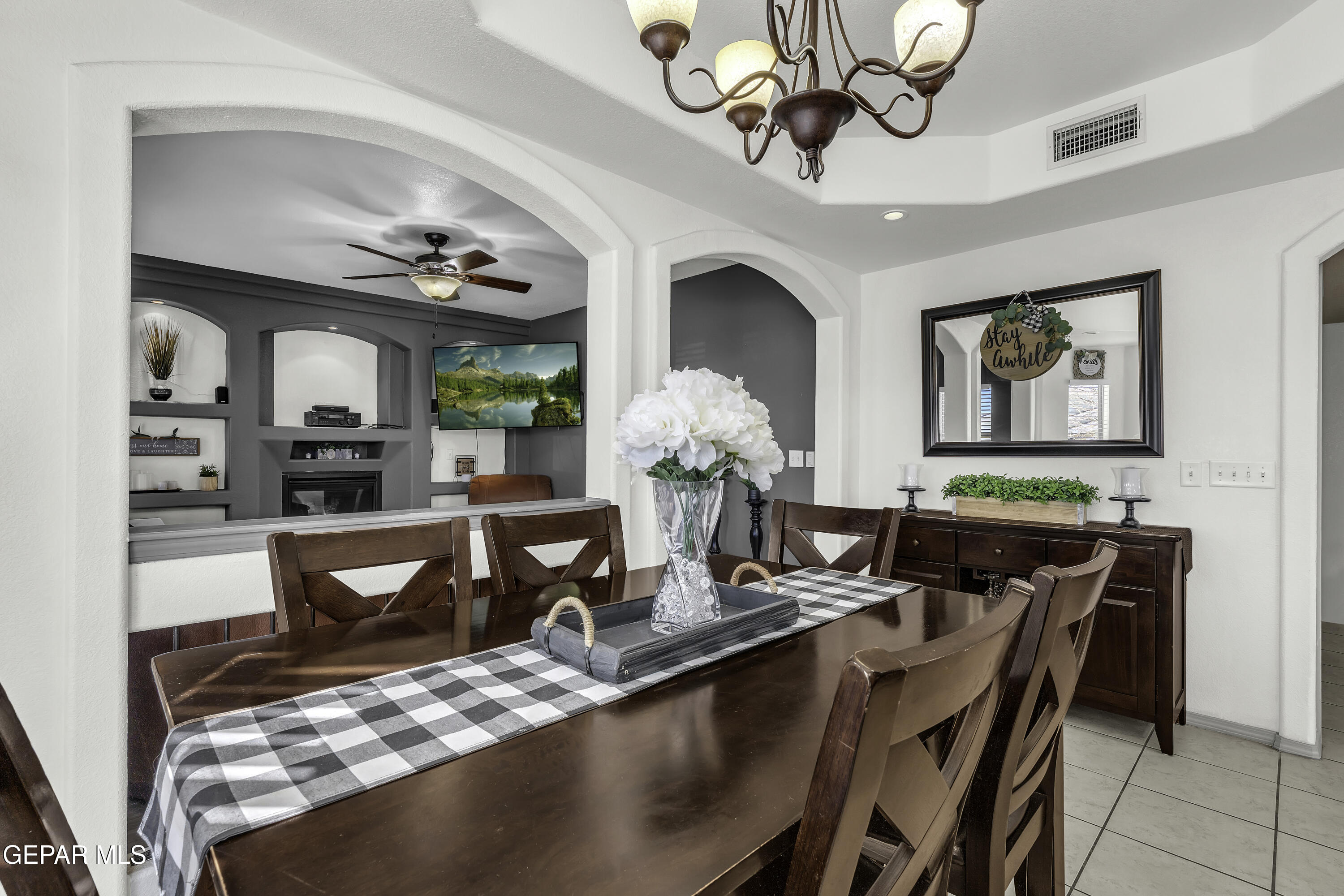 14401 Delta Point Court El Paso, TX 79938 - Photo 20 of 49 a view of a dining room with furniture a chandelier and wooden floor
