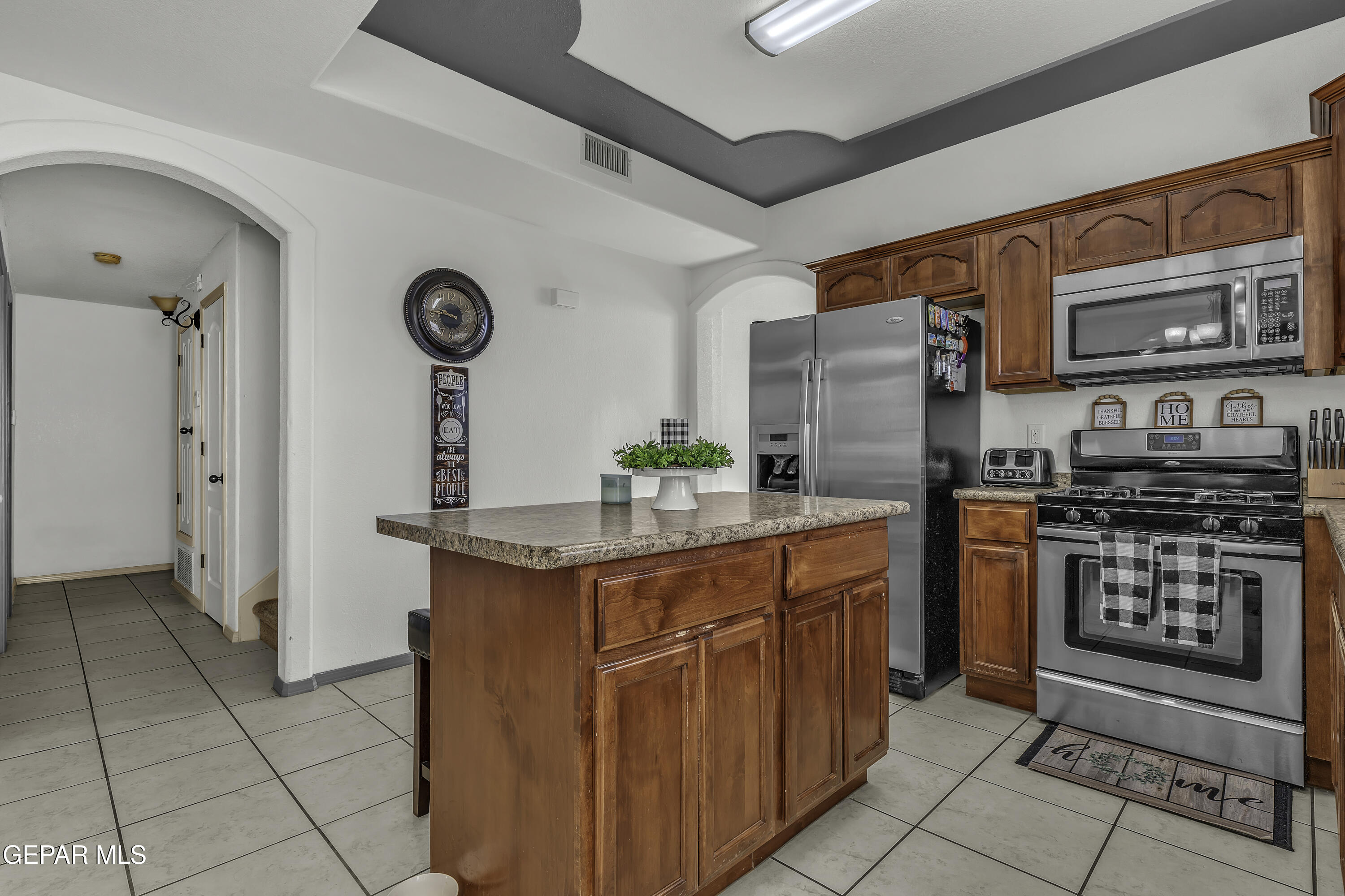 14401 Delta Point Court El Paso, TX 79938 - Photo 41 of 49 a kitchen with stainless steel appliances granite countertop a stove a sink and a refrigerator