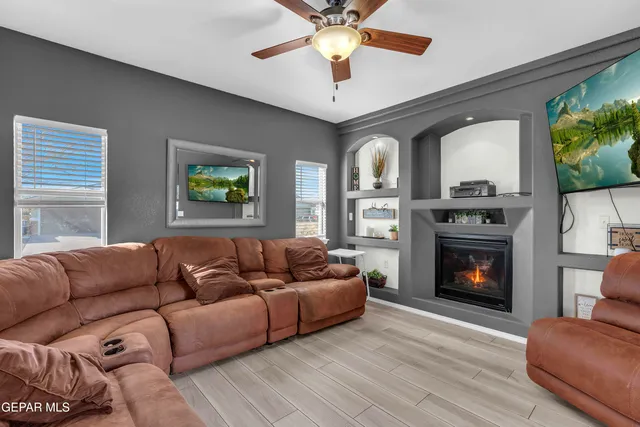 a living room with furniture a fireplace and a flat screen tv