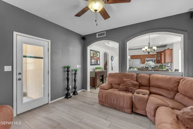 a living room with furniture and a chandelier