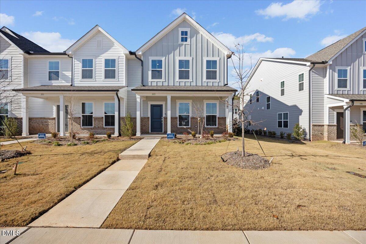 373 Fosterton Cottage Way Raleigh, NC 27603 - Photo 1 of 42 a front view of a house with a yard