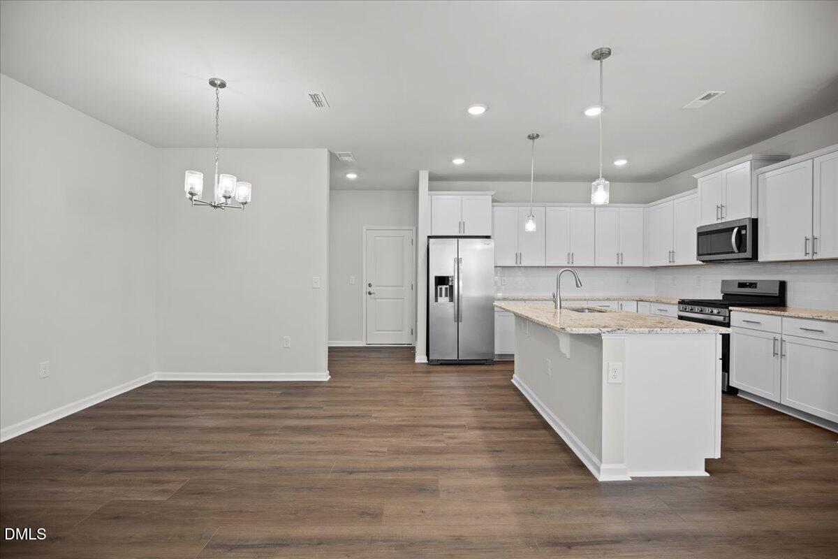 373 Fosterton Cottage Way Raleigh, NC 27603 - Photo 14 of 42 a kitchen with a refrigerator and a microwave