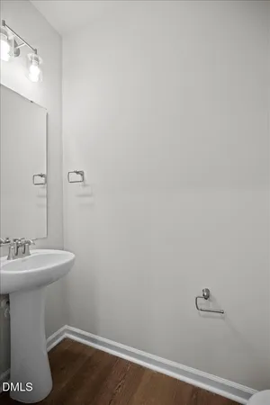 a kitchen with a stove a sink and a white cabinets