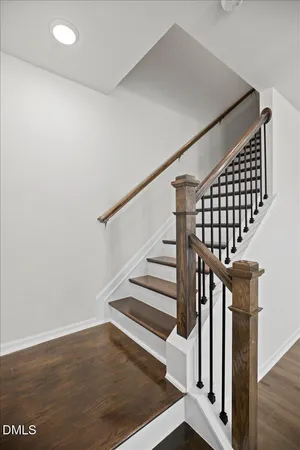 a kitchen with a sink stove and wooden floor