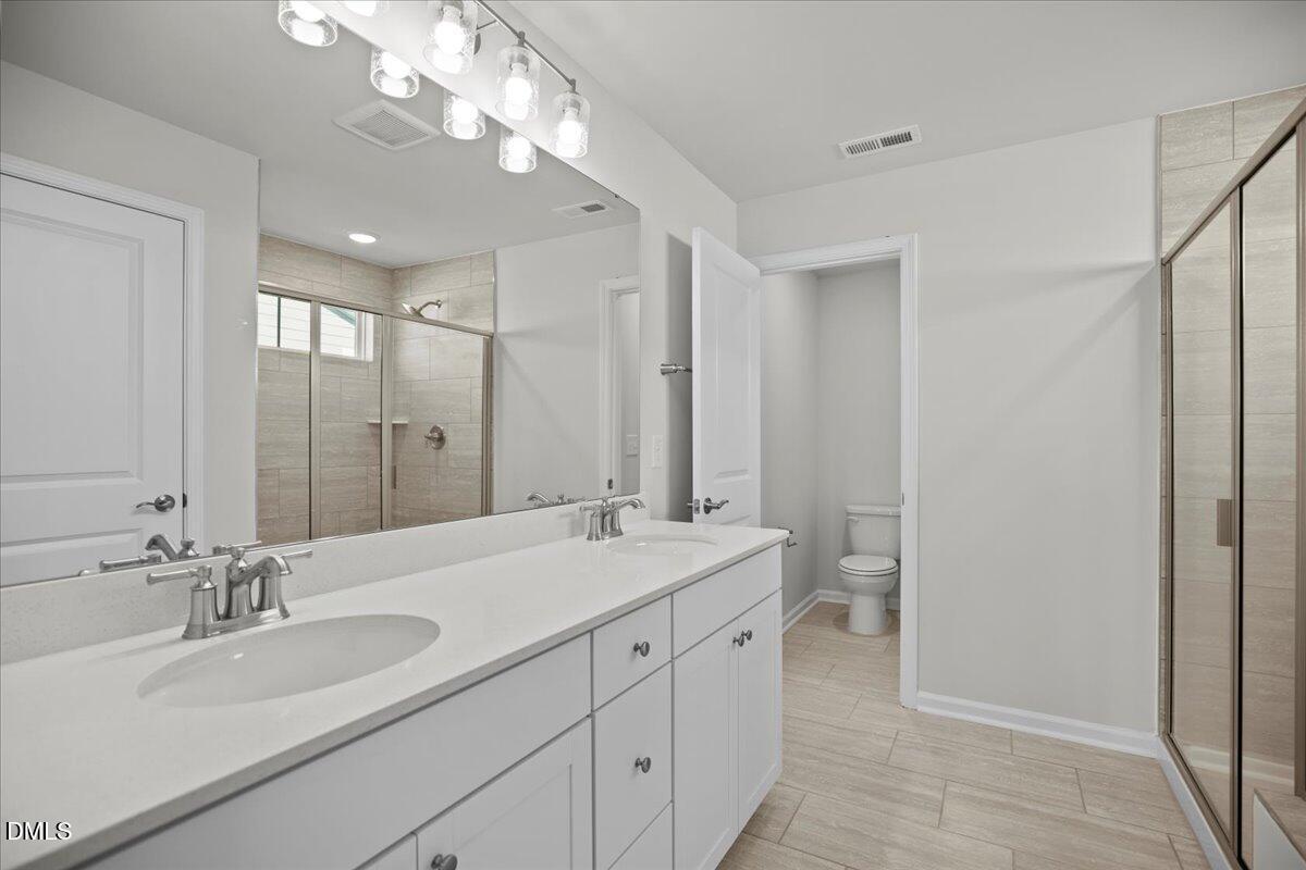373 Fosterton Cottage Way Raleigh, NC 27603 - Photo 23 of 42 a bathroom with a sink double vanity and a mirror