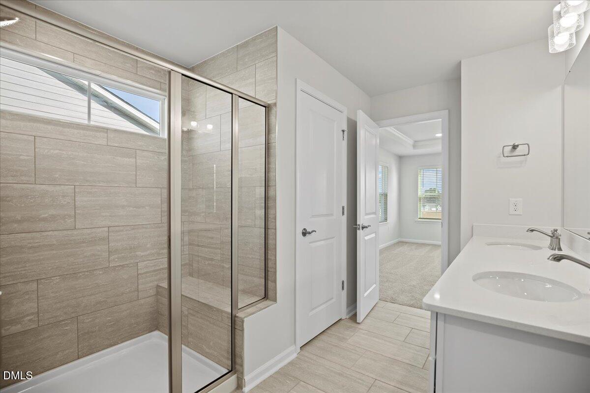 373 Fosterton Cottage Way Raleigh, NC 27603 - Photo 24 of 42 a bathroom with a sink and a mirror