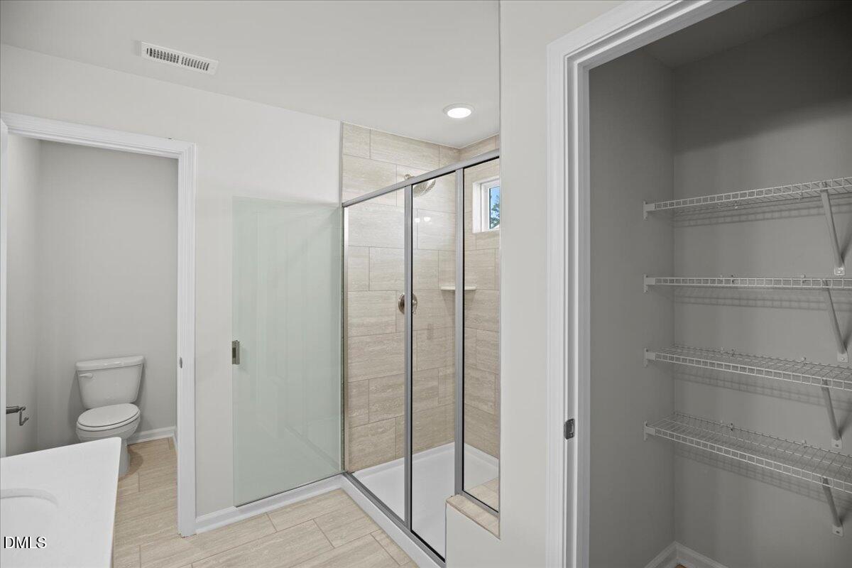 373 Fosterton Cottage Way Raleigh, NC 27603 - Photo 26 of 42 a bathroom with a shower and a toilet