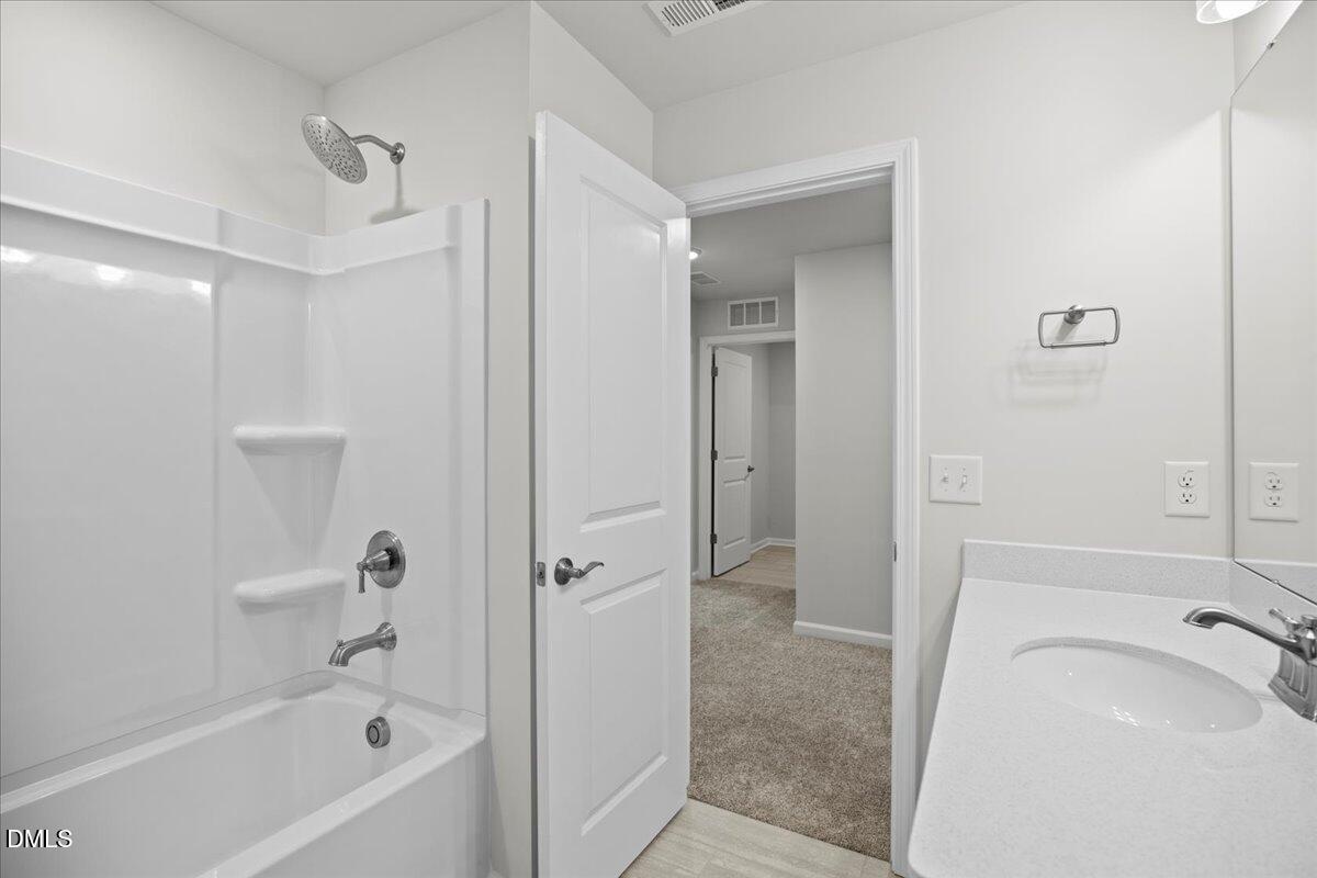 373 Fosterton Cottage Way Raleigh, NC 27603 - Photo 35 of 42 a bathroom with a tub a sink and a shower