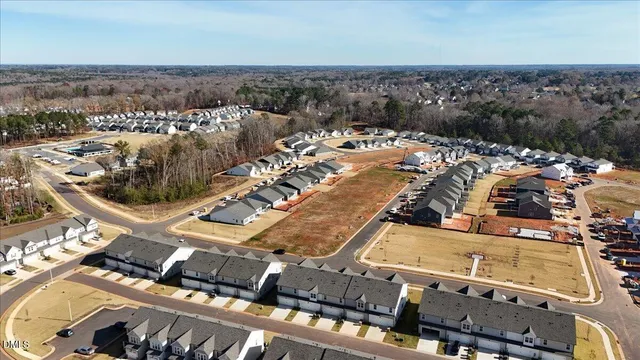 a view of a white house with a swimming pool