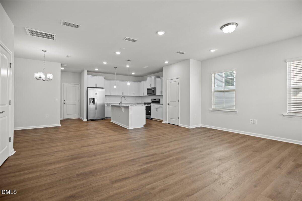373 Fosterton Cottage Way Raleigh, NC 27603 - Photo 5 of 42 a view of kitchen view wooden floor and window