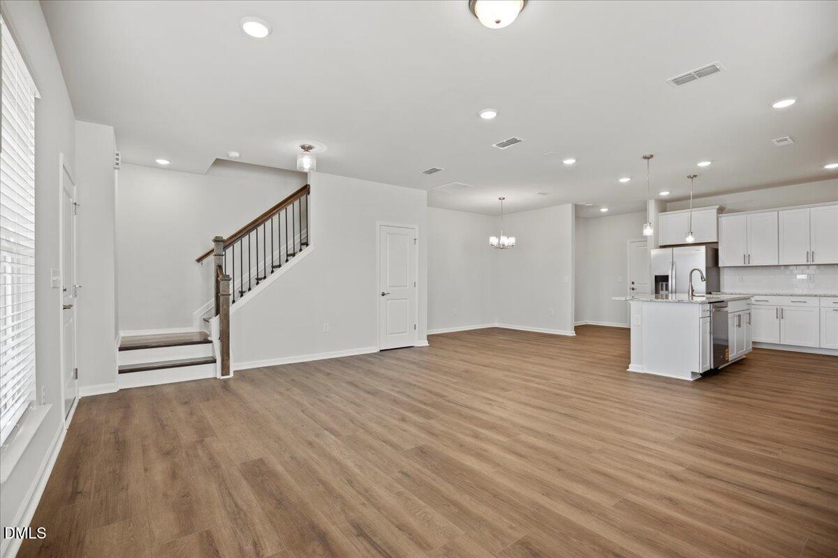 373 Fosterton Cottage Way Raleigh, NC 27603 - Photo 6 of 42 a view of a kitchen with wooden floor and electronic appliances