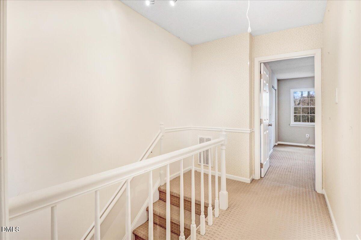 5738 3 Oaks Drive Raleigh, NC 27612 - Photo 23 of 32 a view of staircase with white walls