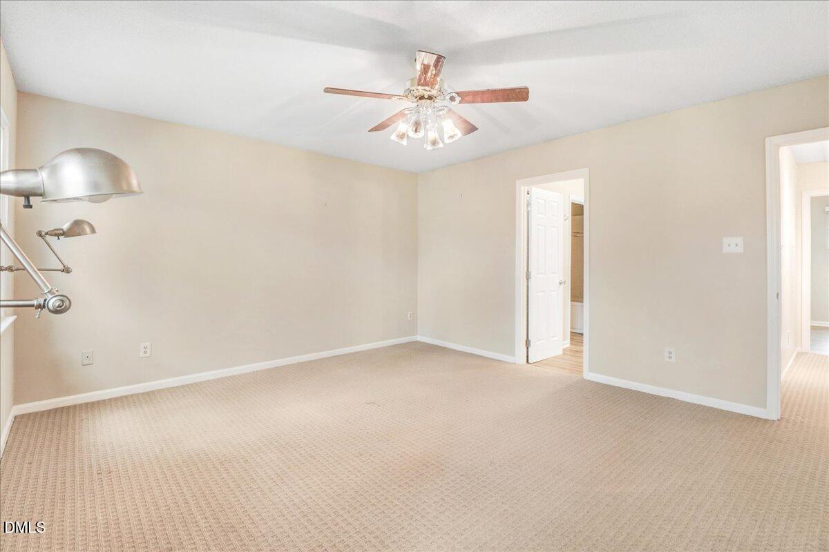 5738 3 Oaks Drive Raleigh, NC 27612 - Photo 25 of 32 an empty room with fan and fan