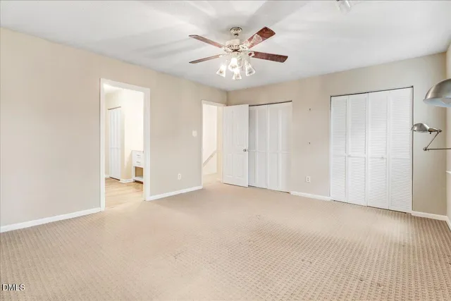 an empty room with fan and fan