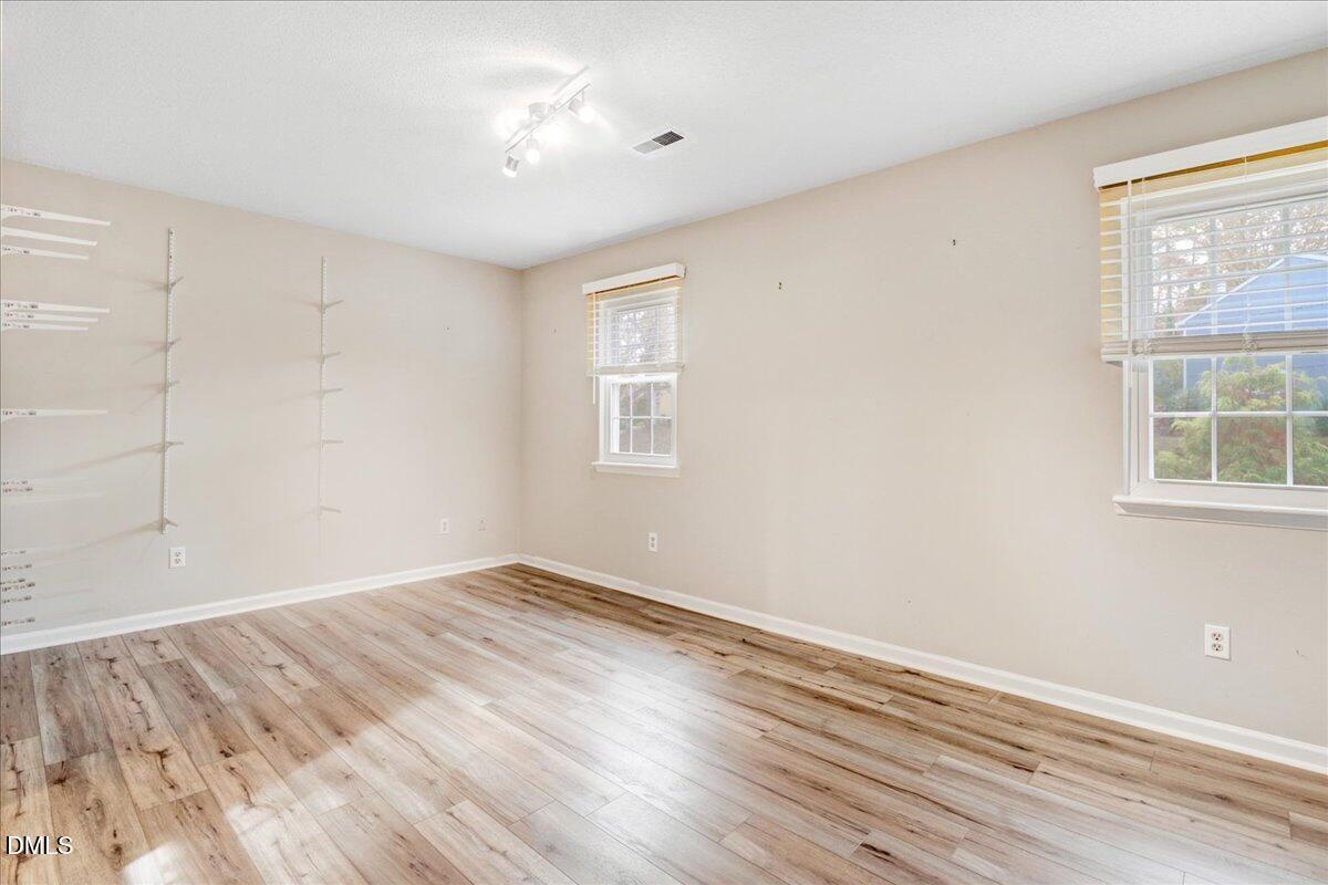 5738 3 Oaks Drive Raleigh, NC 27612 - Photo 29 of 32 a view of empty room with wooden floor and fan