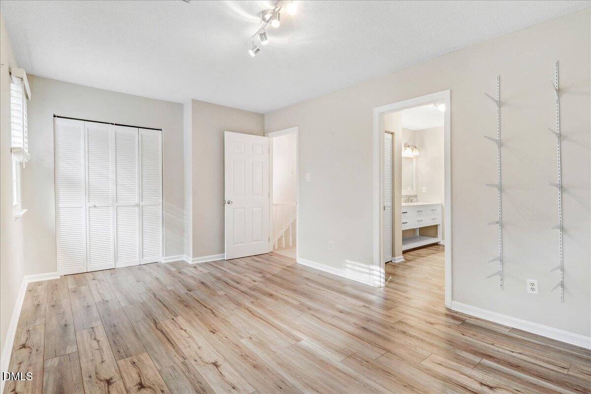 5738 3 Oaks Drive Raleigh, NC 27612 - Photo 30 of 32 a view of an empty room with wooden floor