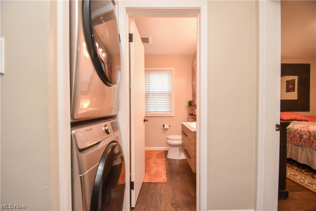 165 Warner Road Hubbard, OH 44425 - Photo 29 of 43 Washroom featuring dark hardwood / wood-style floors and stacked washer and dryer