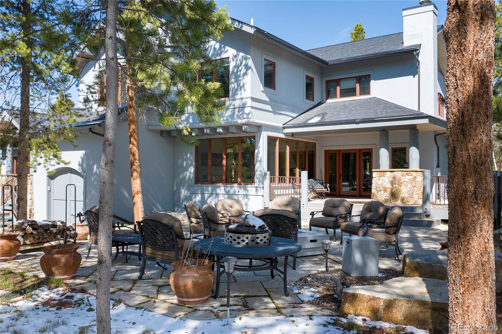 148 County Road Tabernash, CO 80478 - Photo 2 of 45 a view of a patio with table and chairs and potted plants