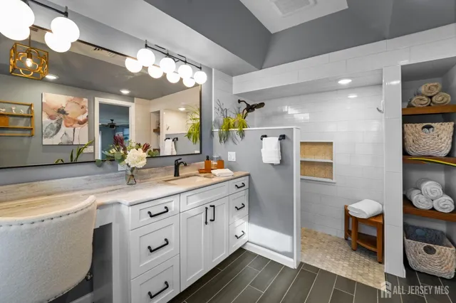 a spacious bathroom with a double vanity sink a mirror and a toilet