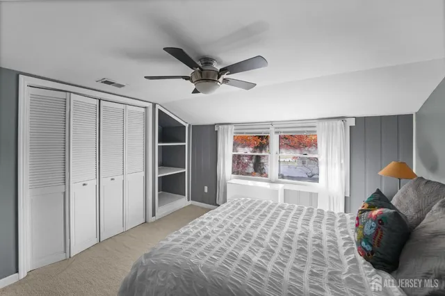 a bedroom with a bed and a large window