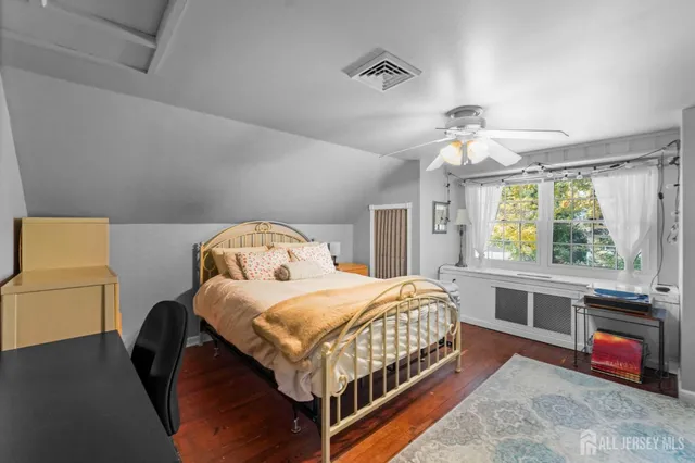 a bedroom with a bed and a large window with the outer view