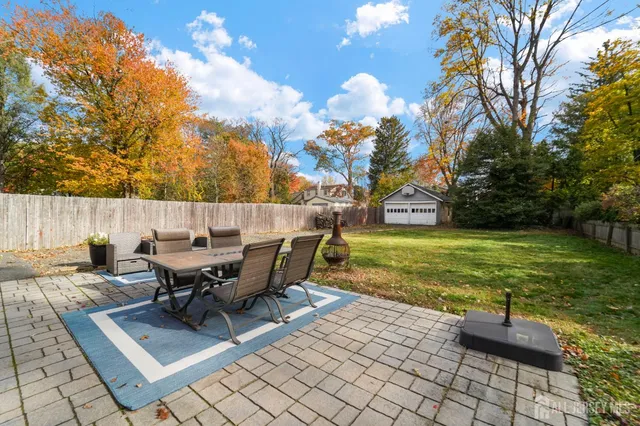 a view of a backyard with sitting area