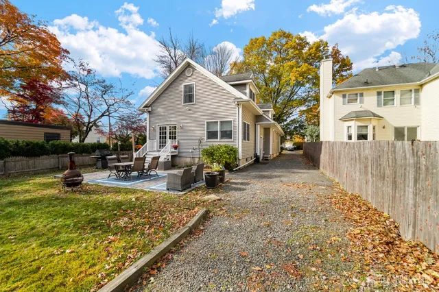 a view of a house with swimming pool and sitting area