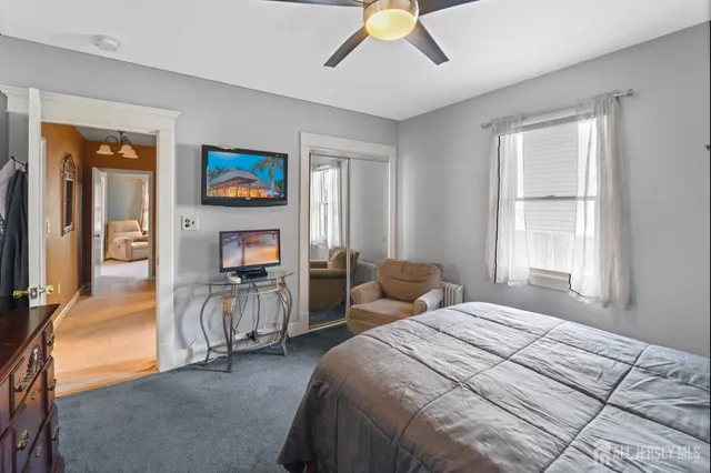 a bedroom with a bed dresser and a window