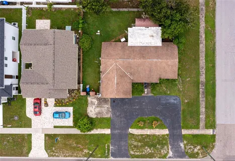 an aerial view of a house with a yard and a large pool