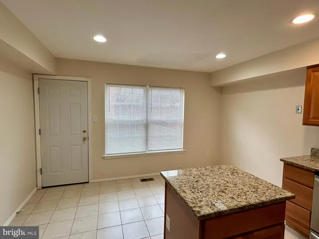 a kitchen with stainless steel appliances granite countertop a stove a refrigerator a sink and dishwasher