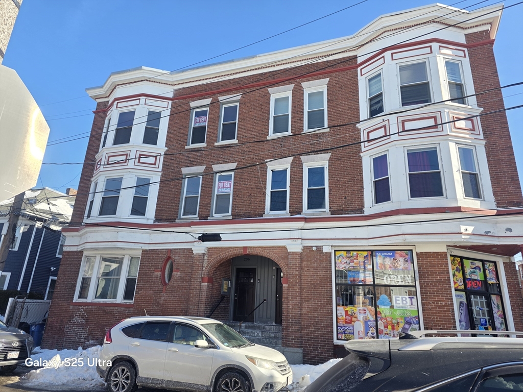 a front view of a building with parking space