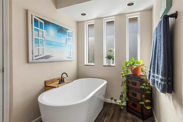a white bath tub sitting next to a blue sink