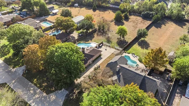 an aerial view of a house with a yard and garden