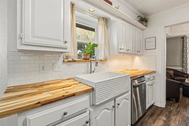 a kitchen with stainless steel appliances granite countertop a sink a stove and cabinets