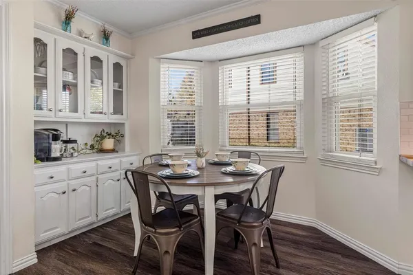 a dining room with furniture a rug and wooden floor