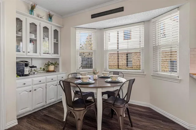 a dining room with furniture a rug and wooden floor