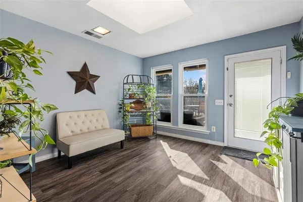 a living room with furniture and a potted plant