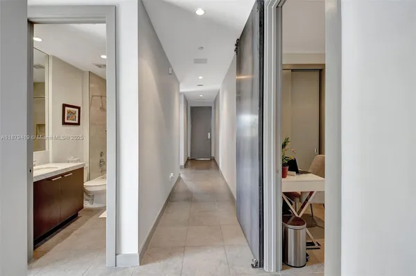 a view of a hallway with wooden shelves