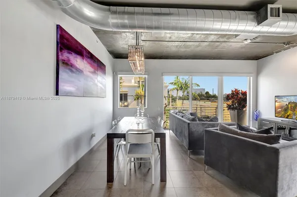 a kitchen with stainless steel appliances kitchen island granite countertop a table and chairs