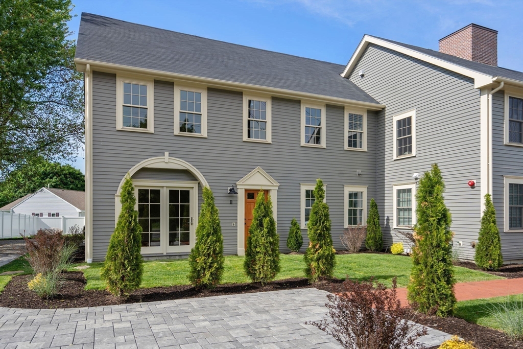 97 Bacon Street, Unit B Natick, MA 01760 - Photo 1 of 37 a front view of a house with garden