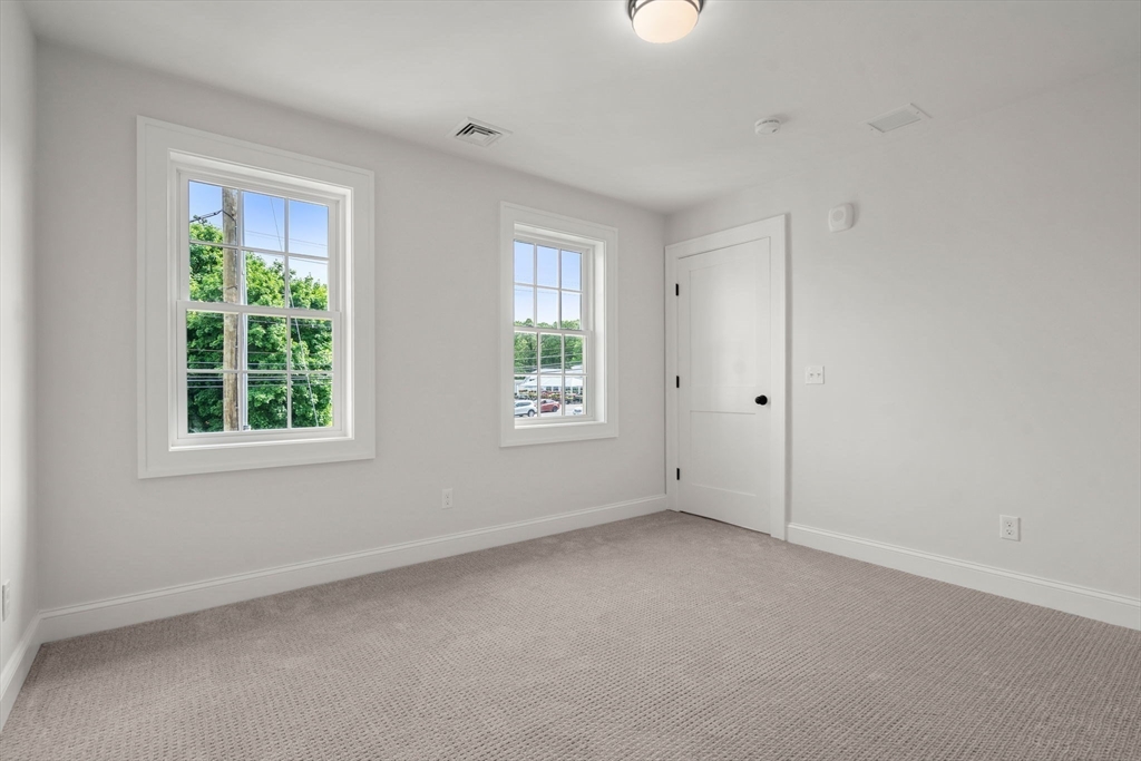 97 Bacon Street, Unit B Natick, MA 01760 - Photo 14 of 37 an empty room with windows