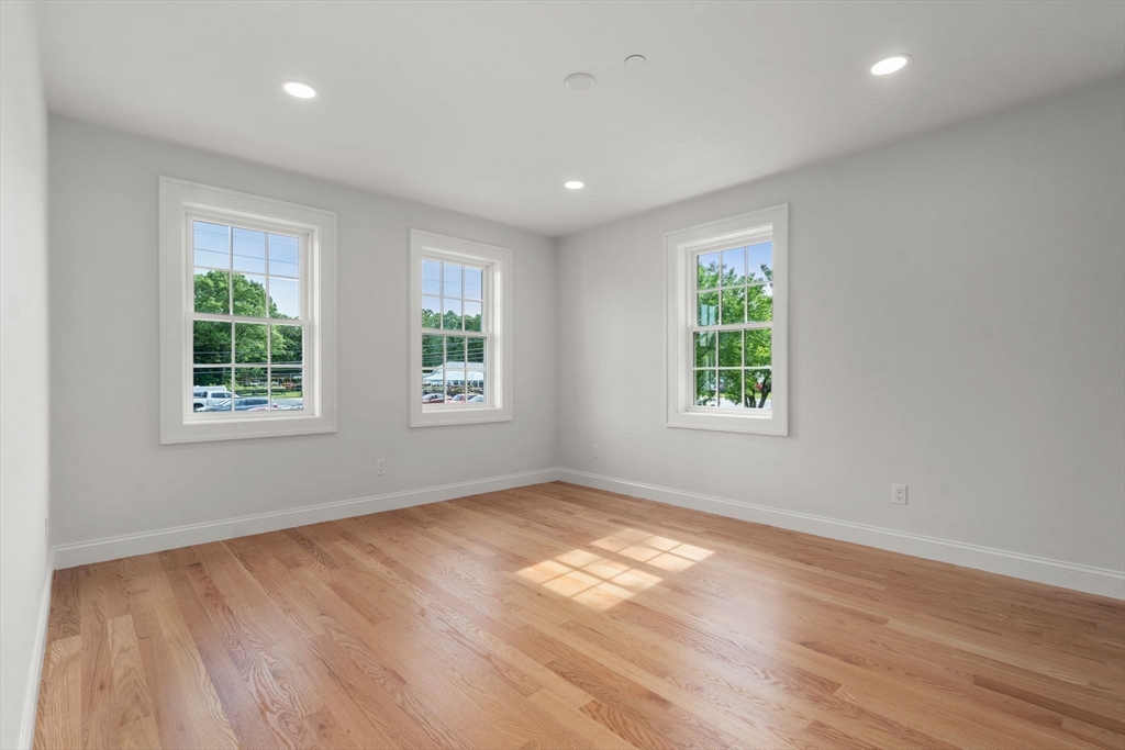97 Bacon Street, Unit B Natick, MA 01760 - Photo 15 of 37 an empty room with wooden floor and windows