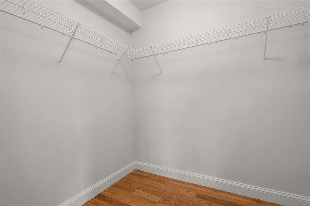 97 Bacon Street, Unit B Natick, MA 01760 - Photo 17 of 37 a view of a room with racks on the wall