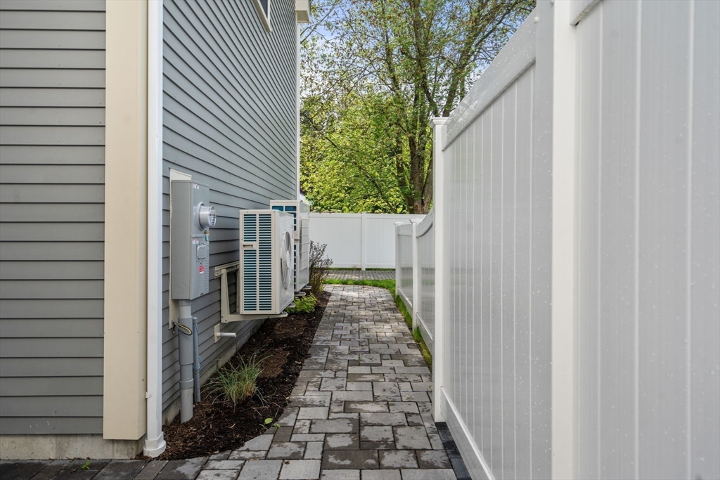 97 Bacon Street, Unit B Natick, MA 01760 - Photo 19 of 37 a view of a pathway of a house with backyard and wooden fence