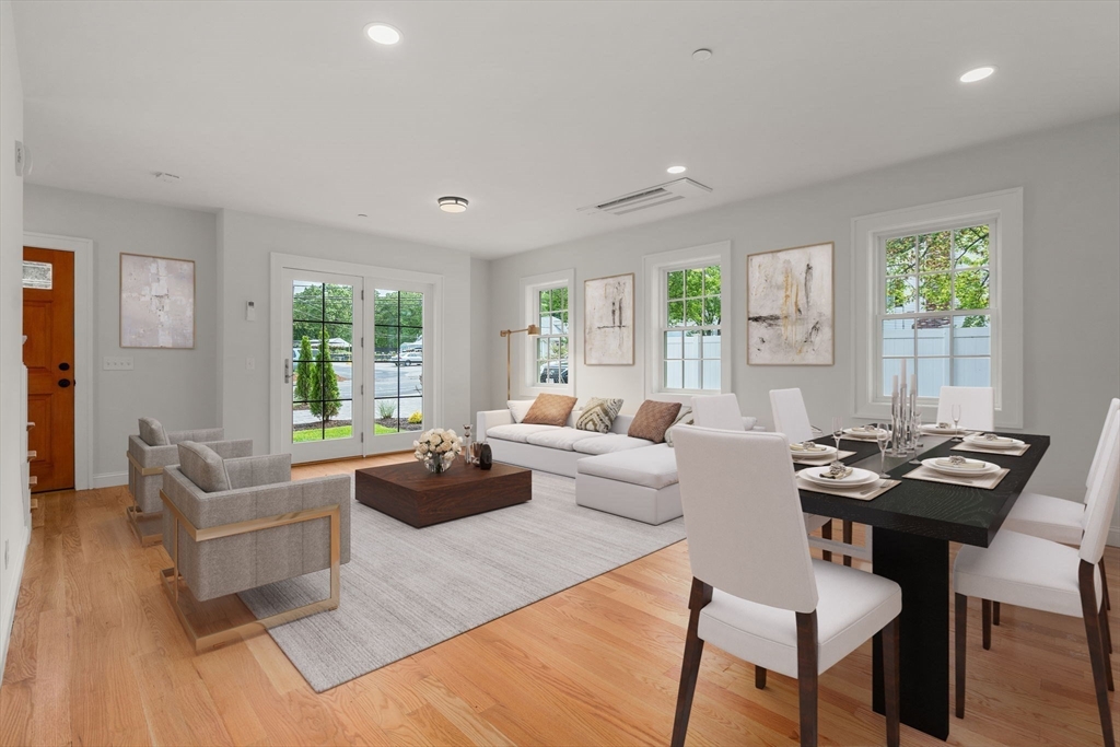 97 Bacon Street, Unit B Natick, MA 01760 - Photo 2 of 37 a living room with fireplace furniture and a large window
