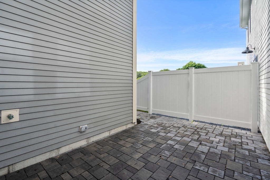 97 Bacon Street, Unit B Natick, MA 01760 - Photo 21 of 37 a view of a backyard