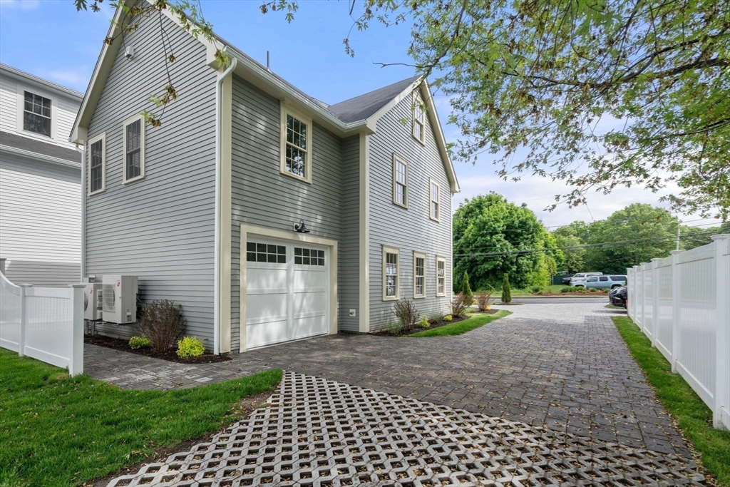 97 Bacon Street, Unit B Natick, MA 01760 - Photo 23 of 37 a view of a house with a yard