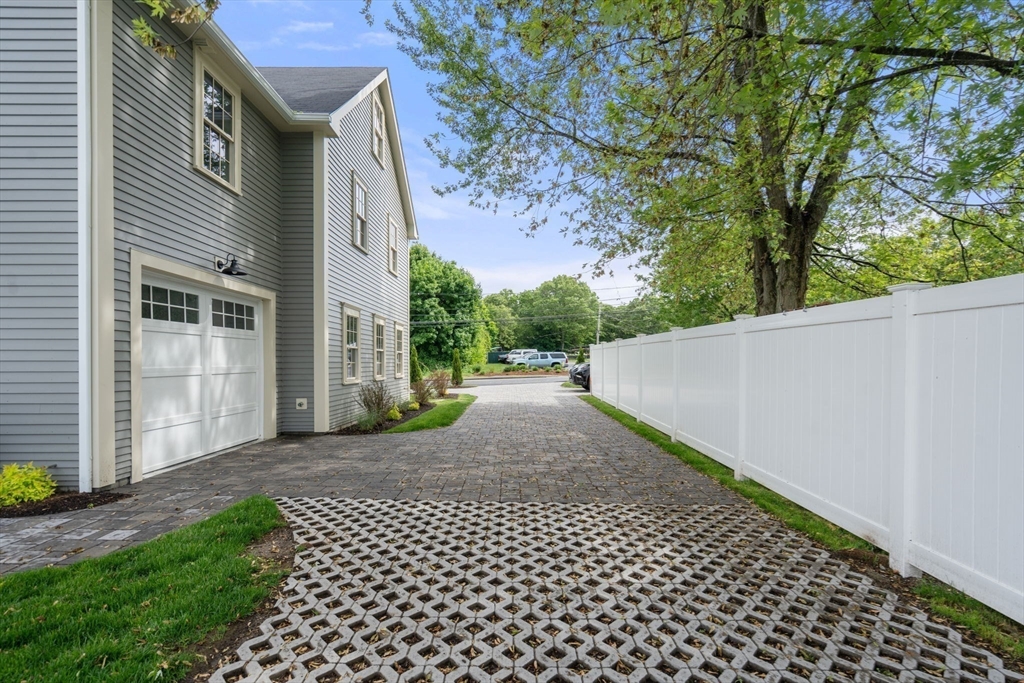 97 Bacon Street, Unit B Natick, MA 01760 - Photo 24 of 37 a view of a back yard of the house